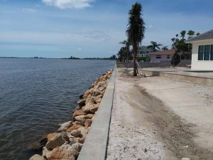 Concrete seawall with coquina rocks