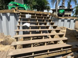 During composite decking staircase and double level seawall installation