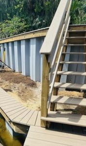 Two level seawall installation to protect from erosion and storm surge including seawall cap and staircase to second level