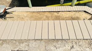 Composite decking over seawall and composite decking sidewalk